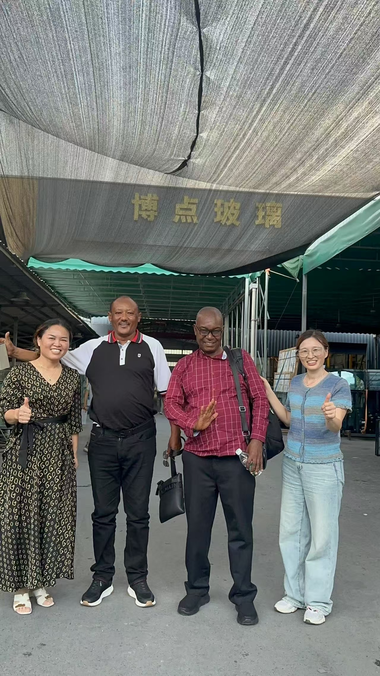 Overseas clients visiting BDGLASS factory entrance in Foshan